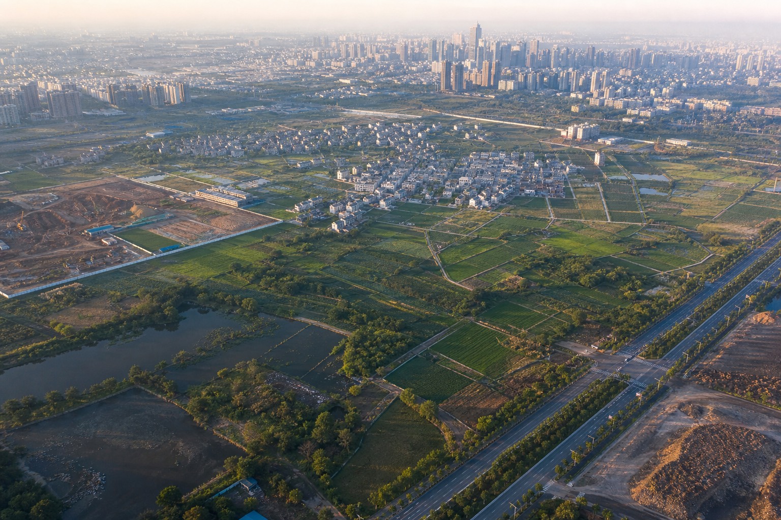 Aerial view of mixed urban land parcels at the city edge, illustrating parcel-level land intelligence